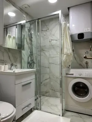 a bathroom with a shower and a washing machine at Tara Two Bedroom Apartment - Budva in Budva