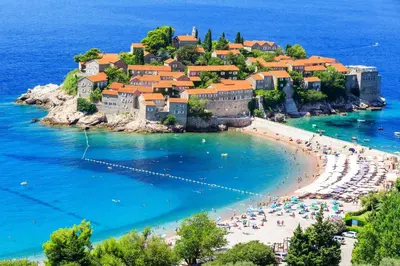 a group of people on a beach in the water at Tara Two Bedroom Apartment - Budva in Budva