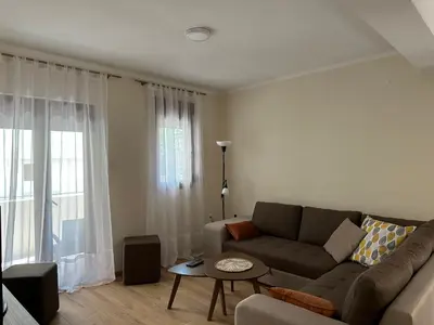 a living room with a couch and a table at Tara Two Bedroom Apartment - Budva in Budva