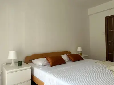 a bedroom with a bed with two pillows on it at Tara Two Bedroom Apartment - Budva in Budva