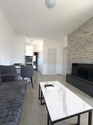 a living room with a couch and a table at D&D I apartments in Sutomore