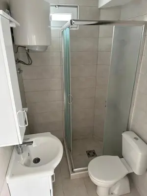 a bathroom with a shower and a toilet and a sink at D&D I apartments in Sutomore