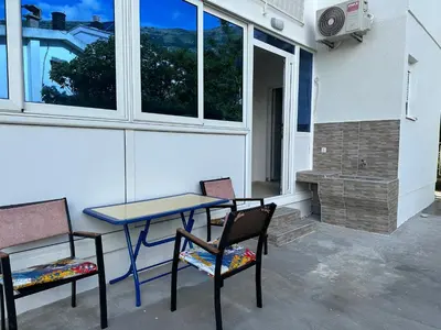 a patio with a table and two chairs and a heater at D&D I apartments in Sutomore