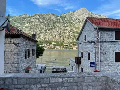 two buildings with a view of a lake and mountains at M&M Bay Haven in Kotor