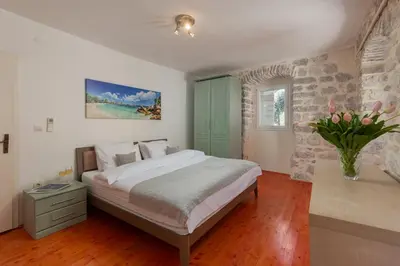 a bedroom with a bed and a green cabinet at M&M Bay Haven in Kotor