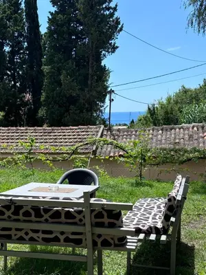 a table and a bench with a table and a chair at Apartments Matija in Sutomore