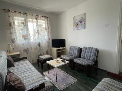 a living room with a couch and two chairs and a table at Apartments Matija in Sutomore