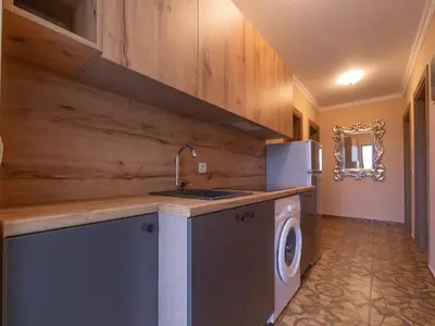 a kitchen with a sink and a washing machine at Apartments Nona in Ulcinj