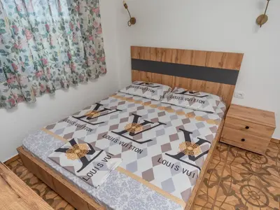 a bedroom with a bed with a quilt on it at Apartments Nona in Ulcinj