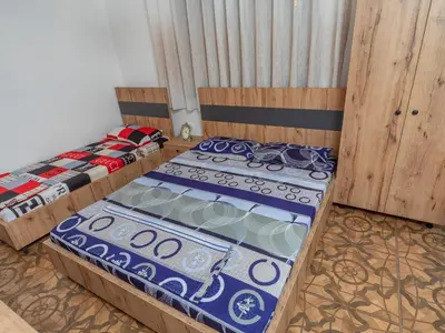 two beds sitting in a room with at Apartments Nona in Ulcinj