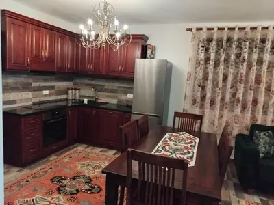 a kitchen with a dining table and a refrigerator at Apartments Nona in Ulcinj