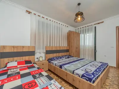 a bedroom with two beds and a lamp at Apartments Nona in Ulcinj