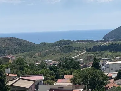 a view of a town with the ocean in the background at Best View Apartment in Sutomore