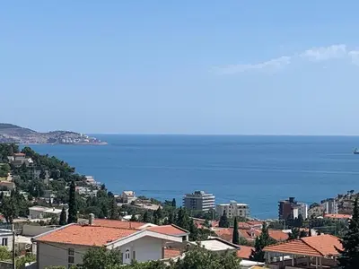 a view of a city with the ocean in the background at Best View Apartment in Sutomore