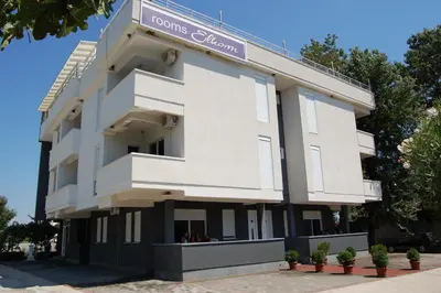 a large white building with a sign on it at Vila Elkom, Apartment 5 in Ulcinj
