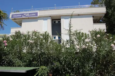 a white building with a sign on top of it at Vila Elkom, Apartment 5 in Ulcinj