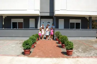 a group of people standing in front of a building at Vila Elkom, Apartment 5 in Ulcinj