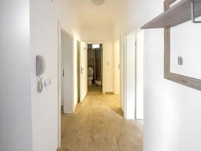 a hallway with white walls and a hallway with a hallway at Appartment Frick in Sutomore