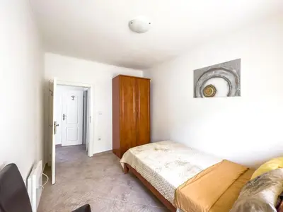 a bedroom with a bed and a wooden cabinet at Appartment Frick in Sutomore