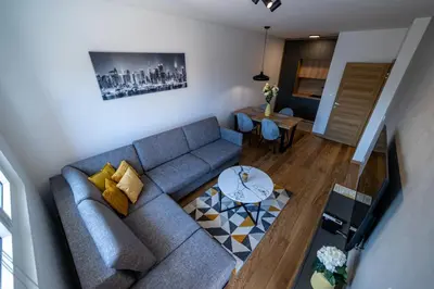 a living room with a couch and a table at Apart Kraft in Podgorica