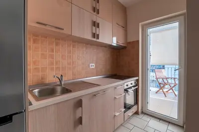 a kitchen with a sink and a stove top oven at Apartment Xenia in Petrovac na Moru