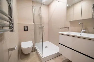 a bathroom with a shower and a toilet and a sink at Apartment Xenia in Petrovac na Moru