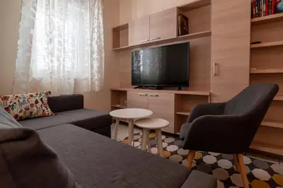 a living room with a couch and a flat screen tv at Apartment Xenia in Petrovac na Moru