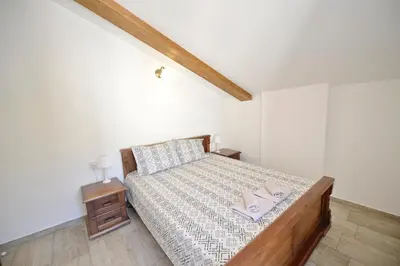a bedroom with a bed with two pillows on it at Old Town View - Romantic & Super Stylish in Kotor