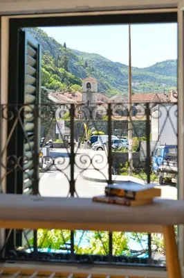a window with a view of a parking lot at Old Town View - Romantic & Super Stylish in Kotor