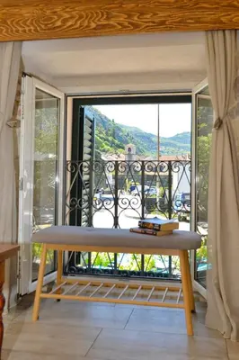 a bench in front of a balcony with a view at Old Town View - Romantic & Super Stylish in Kotor