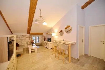 a kitchen and living room with a table and chairs at Old Town View - Romantic & Super Stylish in Kotor
