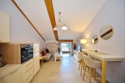 a kitchen and living room with a table and chairs at Old Town View - Romantic & Super Stylish in Kotor