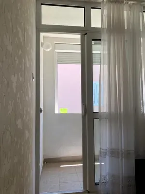 an open door with a window in a room at Ćetković in Petrovac na Moru
