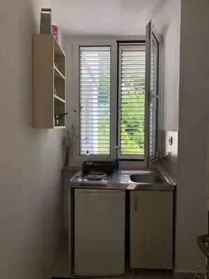 a kitchen with a sink and a window at Ćetković in Petrovac na Moru