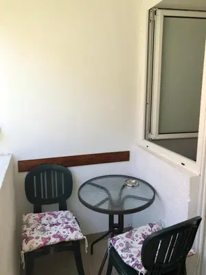 a small table and two chairs in a small room at Ćetković in Petrovac na Moru