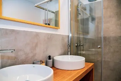 a bathroom with a sink and a shower at Golden Suit Tivat Heights-Pool & Seaview C1 in Kavač