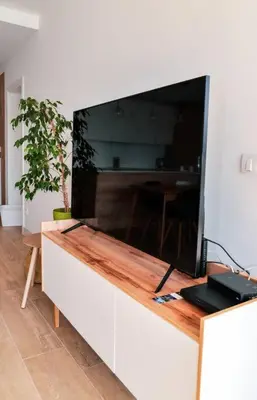 a large flat screen tv sitting on top of a cabinet at Golden Suit Tivat Heights-Pool & Seaview C1 in Kavač
