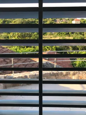 a view through the blinds of a window at Skalina House in Tivat