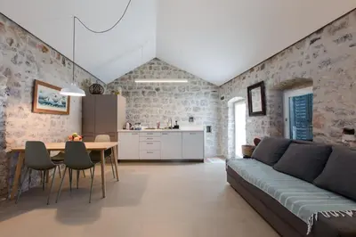 a living room with a couch and a table at Skalina House in Tivat