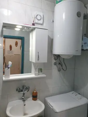 a bathroom with a sink and a toilet and a mirror at Apartmani Ema in Sutomore