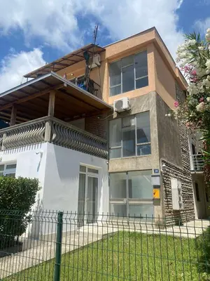 a house with a fence in front of it at Apartmani Ema in Sutomore