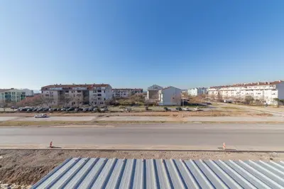 a view of an empty road with buildings in the background at Plum Apartment in Podgorica