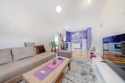 a living room with a couch and a table at Plum Apartment in Podgorica