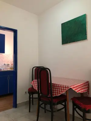 a table with chairs and a red and white table cloth at Ćetković 1 in Petrovac na Moru