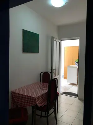 a table with a checkered table cloth on it in a room at Ćetković 1 in Petrovac na Moru