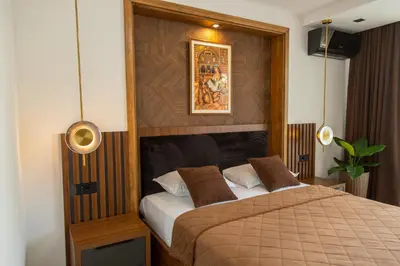 a bedroom with a bed with a wooden headboard at Apartments Milla in Ulcinj