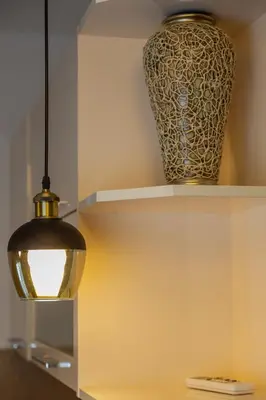 a vase sitting on a shelf next to a lamp at Apartments Milla in Ulcinj