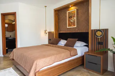 a bedroom with a large bed with a wooden headboard at Apartments Milla in Ulcinj
