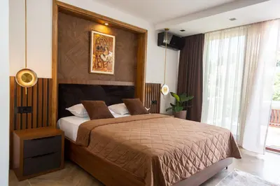 a bedroom with a large bed with a wooden headboard at Apartments Milla in Ulcinj