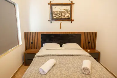 a bedroom with a bed with two towels on it at Apartments Milla in Ulcinj